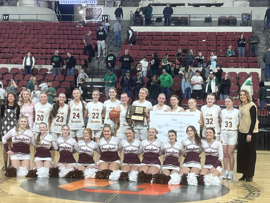 Baker girls basketball team poses with their trophy.