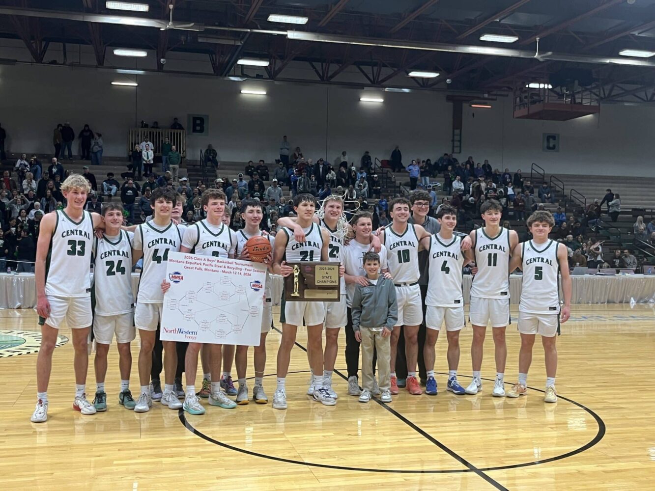 Billings Central Boys Basketball Team poses for a picture with the State Champion Trophy